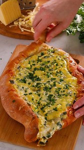 The traditional Georgian 🇬🇪 dish Khachapuri is a soft, cheese-filled bread filled with cheese, eggs, and other ingredients. We put our twist on it with creamy & nutty Swiss Raclette cheese and briny imported Greek Feta, then we added swiss chard. Pull the bread and cheese apart for a delicious table centerpiece at your next dinner party. Get the recipe: https://iloveimportedcheese.com/recipe/swiss-chard-and-raclette-khachapuri/ | I Love Imported Cheese