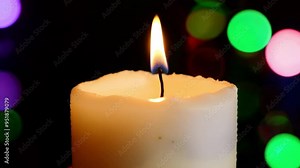 A soothing video of a candle flame flickering gently, creating a calming rhythm.