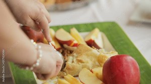 Woman at buffet table slicing into pastry at a baby shower party Stock Video