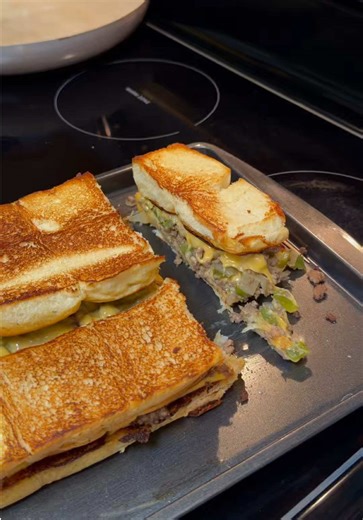 Ground Beef • Chop and dice green bell pepper and sweet onion • Sauté until soft, then set aside • Brown ground beef, drain excess grease • Stir in peppers and onions • Season with Famous Dave’s Steak & Burger Seasoning Buttered Rolls • Melt butter in a warm pan • Slice rolls through the middle, keeping them connected • Lightly brown both tops and bottoms in butter Assembly • Place roll bottoms down and add sliced cheese • Spoon on the seasoned beef, then add another layer of cheese • Add roll t