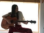 Scout Willis sings an emotional song and plays the guitar