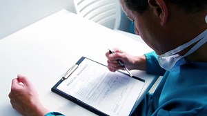 Doctor filling medical insurance form | Free Stock Video Footage