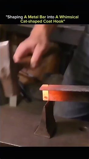 KNOWLEDGE ILLUSION on Instagram: "Shaping a metal bar into a whimsical cat-shaped coat hook is where art meets physics. What starts as a straight steel bar becomes a playful cat through heat, force, and careful control. The metal is heated until it reaches a plastic state, where its internal structure loosens and allows bending without cracking. Using jigs, hammers, and controlled pressure, the maker curves, twists, and forms each section to define ears, tail, and posture. As the metal cools, it