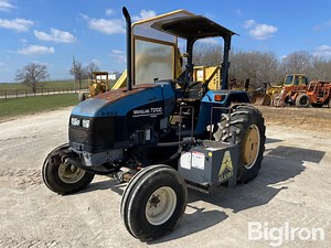 New Holland TS100 2WD Tractor W/Alamo 50 Boom Axe Mower | Agriculture