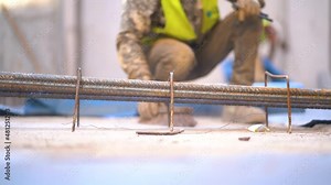 Dirty Caucasian laborer clean and sweep dust in a construction site, close up static