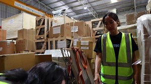 clip-1093492145-two-women-worker-carrying-lifting-heavy-cardboard