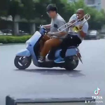 Try not to laugh - Guys on a scooter with a trombone #shorts