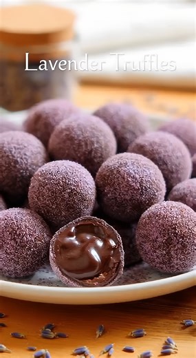 Indulge in these velvety, herb-infused dark chocolate delights that bring a touch of floral elegance to your dessert plate 🍫🌿✨ 🛒 Ingredients : 225 grams High-quality dark chocolate (60% to 70% cacao), finely chopped 120 milliliters Heavy whipping cream (36% fat) 2 teaspoons Dried culinary-grade lavender buds 1 pinch Fine sea salt 30 grams Unsweetened cocoa powder 1 tablespoon Granulated sugar mixed with one drop of purple food coloring 👩‍🍳 Easy Steps : 🥣 Infuse and Strain - Combine the hea