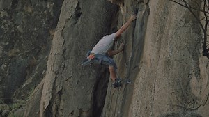 Experienced mountaineer climbing a rocky mountain - Free Stock Video
