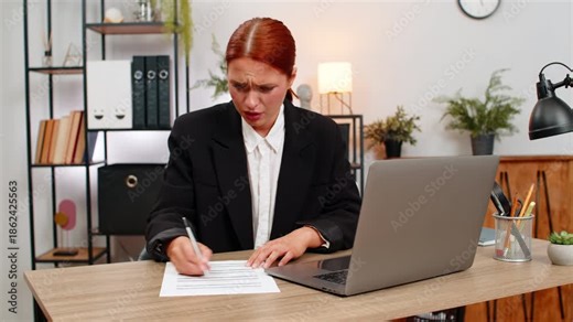 Young businesswoman at home office tears draft report after spotting error and decides fresh start immediately. Freelancer girl at table opens new file typing fast very focused on clear accurate text