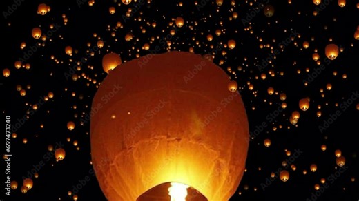 Floating lantern. A large group of Chinese flying lanterns. Chinese sky lanterns floating in a dark night sky