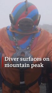Watch as Lloyd Scott, 58, reaches the peak of Snowdon - in a 130lb diving suit 💪 | BBC Wales News