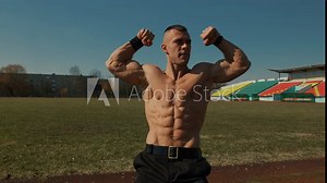 Bodybuilder showing double biceps in front and maximum muscularity. Poses demonstrate musculature of arms, volume and peak of biceps and overall development of muscles in front. Slow motion