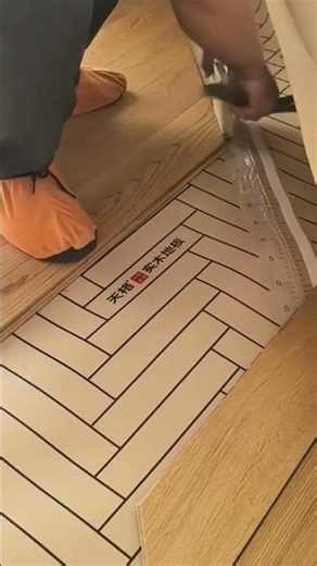 Installing wood floor planks in a herringbone pattern with precision tools