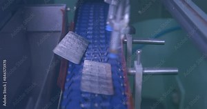concept of automatic packaging, robotic arm machine puts medicine strips on conveyor belt. medicine packing machine. machine releasing sealed medicine on conveyor belt pharmaceutical manufacturing