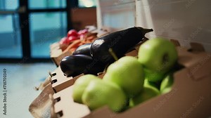 Locally grown ripe fruits and vegetables sold at zero waste shop, nonpolluting ethically sourced produce in crates. Empty supermarket with natural merchandise. Handheld shot. Close up.