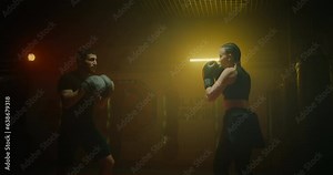 female boxer training with coach in gym, striking punching focus mitts on male hands, 4K, Prores