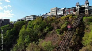 Aerial view of Duquesne Incline and Mount Washington in Pittsburgh, Pennsylvania, drone follows funicular railway car on the way to the top station