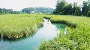 Nature's serenity: Kayaking on a lush lake, an adventure amidst green landscapes. Reconnect, paddle, embrace tranquility. Explore allure of untamed beauty. Enjoy the traveling holiday in austria.