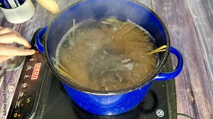 Boiling spaghetti in a saucepan on an induction stove. Cooking spaghetti Bolognese.