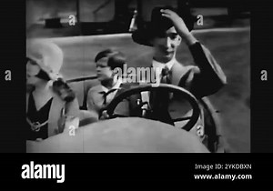 US - 1927 - in this silent comedy, a car has a flat tire. The driver stops on a hill and gets the spare while his family waits in the car. The spare rolls down the hill, and he runs after it Stock Video Footage - Alamy