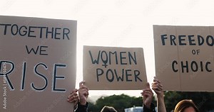 Diverse women doing demonstration for female rights on city street - Feminism concept - Main focus on center banners