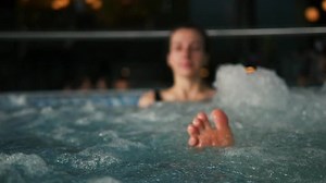 Young girl in swimming-pool. Legs, close-up