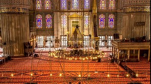 Time Lapse scene inside the Blue or Sultan Ahmet Mosque in Istanbul. 4K Time Lapse. Tilt Shift from left to right.