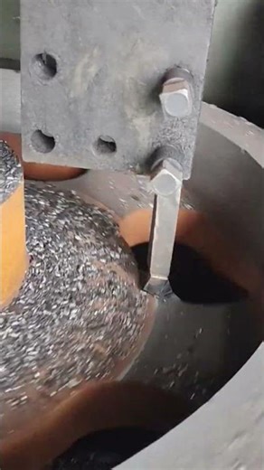the process of scraping an iron piece in the middle using an engraving tool
