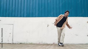 Hispanic funny choreographer dancing in hip hop style. Young happy break dancer perform b-boy dance. Motion shot of funny man practicing street dancing. Outdoor sport 2024. Modern dance. hiphop.