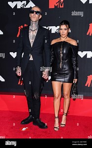Travis Barker and Kourtney Kardashian walking on the red carpet at the 2021 MTV Video Music Awards held at the Barclay's Center in Brooklyn, NY on September 12, 2021. (Photo by Anthony Behar/Sipa USA Stock Photo - Alamy