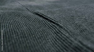 A closeup view of soft textured fabric in a deep, dark color with rich details and features