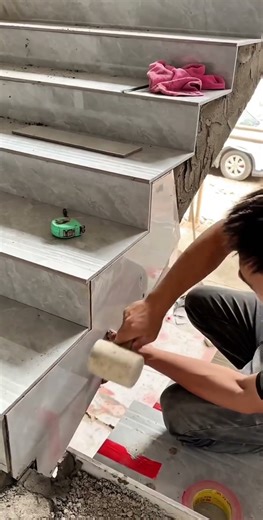 Example of ceramic tile installation process on stair tread surfaces in a row and tightly packed