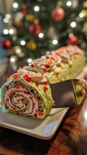 FESTIVE PISTACHIO ROLL CAKE WITH WHIPPED CREAM & CANDIED FRUITS 🎄🌟🍰 INGREDIENTS: For the Pistachio Sponge Cake: 4 large eggs 1/2 cup granulated sugar 1 teaspoon vanilla extract 2/3 cup all-purpose flour 1/4 cup finely ground pistachios 1/2 teaspoon baking powder Pinch of salt Green food coloring (optional, for a brighter holiday look) For the Filling: 1 1/2 cups whipping cream 2 tablespoons powdered sugar 1/2 teaspoon vanilla extract 1/3 cup red berry jam (raspberry or strawberry) 1/3 cup mix