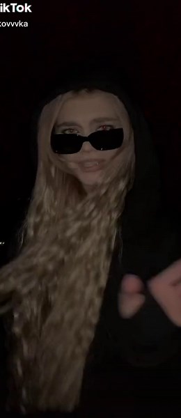 Mysterious Outdoor Night Scene with Gesturing Individual