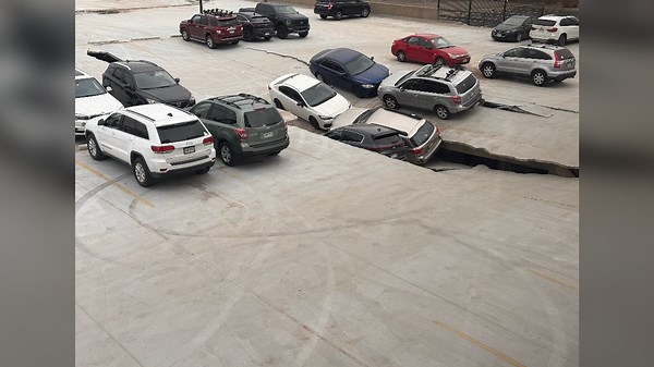 Multiple vehicles crushed as floor of parking garage collapses