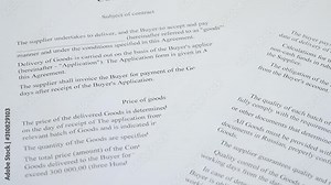 Abstract the text of the contract on paper closeup. The pen is on the paper with the contract. Business, responsibilities, partnership.