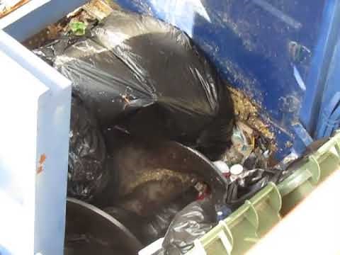 Auger compactor packing garbage