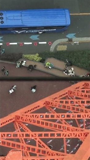 Tokyo Tower's "Skywalk Window" with large sightseeing buses passing directly underneath