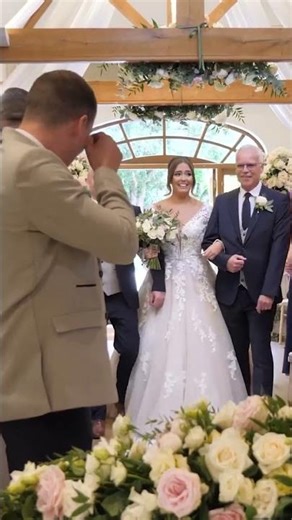 Bride walks down the aisle - emotional groom
