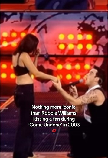 Robbie Williams Kisses Fan During Iconic Performance