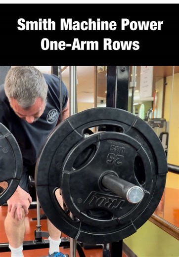 To build a big back, brute force, power exercises should be part of your training. Using the Smith Machine for one-arm rows is one of the best ways to do this. It stabilizes the bar for you, allowing you to focus on powering the weight up. This one takes a bit of practice as you don’t want to just heave the weight up. There is some technique to it. The first bit uses your legs and lower back to get the weight moving up. Once the weight is moving, then start to row as powerfully as you can to kee
