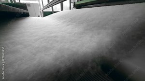 Synthetic fabric moving on industrial line.