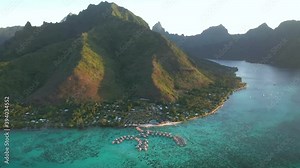 Drone aerial view Tahiti 4k. Flying above Moorea island. Overwater bungalow villas in clear water lagoon. French Polynesia. Exotic travel vacation getaway, romantic honeymoon destination.