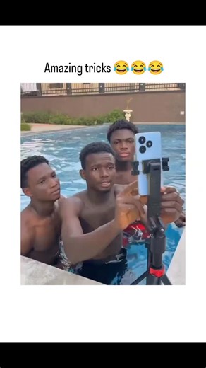 @viral_content_1812 on Instagram: "This Instagram reels shares a 18-second video of shirtless young men in colorful swim trunks goofing around in an apartment pool, splashing water, striking exaggerated poses for a tripod-mounted camera, and laughing together, captioned "Amazing tricks " to emphasize the silly, improvised fun. Authored by Rwandan agronomist Jacques Muhirwa, a crop scientist who frequently posts humorous clips, this January 27, 2026, entry quickly amassed 62K views, 66 likes, and