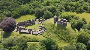 Drone fly up showing the exterior of Okehampton Castle in Devon, UK