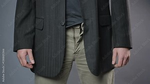 Slim man zipping and unzipping pants zipper, man's clothes, close-up shot