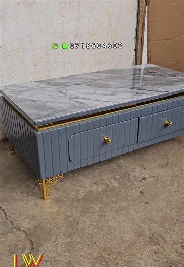 modern grey coffee table. 254 718 604 602. uv marble top. two drawers with hydraulic runners. gold metallic legs. golden ribbon. grey; glossy finish . ksh13500 Now available in our Nairobi umoja and Nakuru KITI stores. we deliver countrywide 🇰🇪. call or WhatsApp 254 718 604 602. #fyp #coffeetable #nakurutiktokers #trendingkenya #nairobitiktokers.