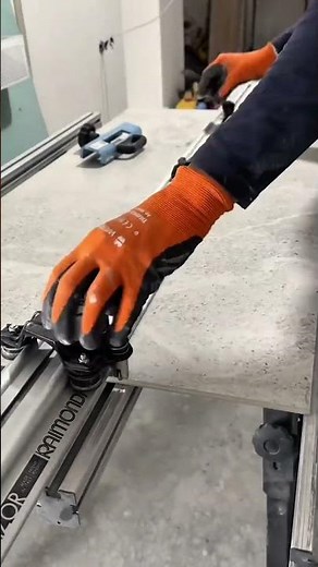 Using a scraper to cut the tiles into two pieces to be installed on the floor neatly. #construction