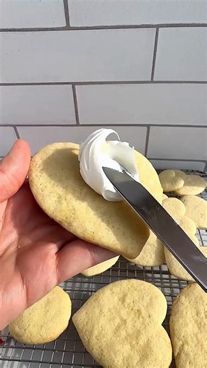 Classic sugar cookies with a creamy frosting, perfect for Valentine’s Day baking! ❤️ Easy Sugar Cookies (we made a half batch in the video) Ingredients: 2 sticks of salted butter 1 heaping cup of sugar ⅓ c Carnation Evaporated Milk 1 tsp vanilla 2 eggs, beaten 1 tsp baking powder 1 tsp baking soda 4 cups all-purpose flour 2-3 tubs of store bought frosting or your favorite buttercream frosting recipe (below) How to make sugar cookies: 1. Preheat the oven to 350 degrees. Line a baking sheet with p